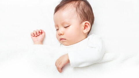 A serene sleeping Tampa Bay baby, epitomizing tranquility and innocence